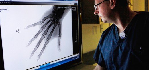 Image: Chief Medical Examiner Eric Pfeifer looks over a digital x-ray on March 21.