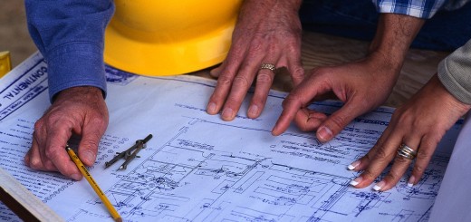 Hands of Couple Looking at Blueprints